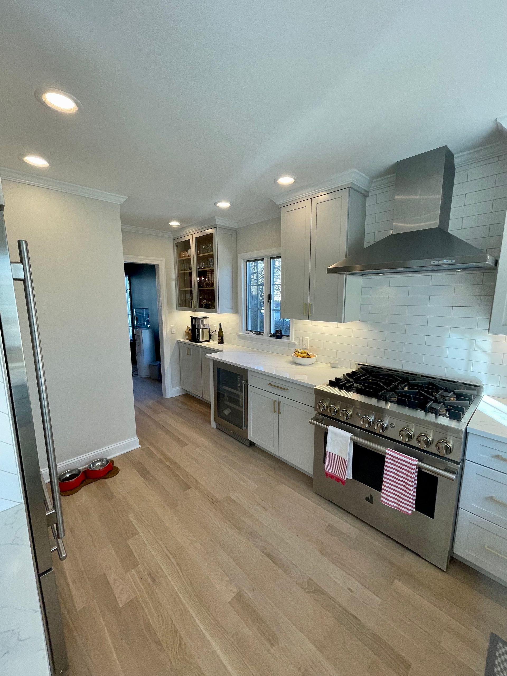 A kitchen with stainless steel appliances and hardwood floors.