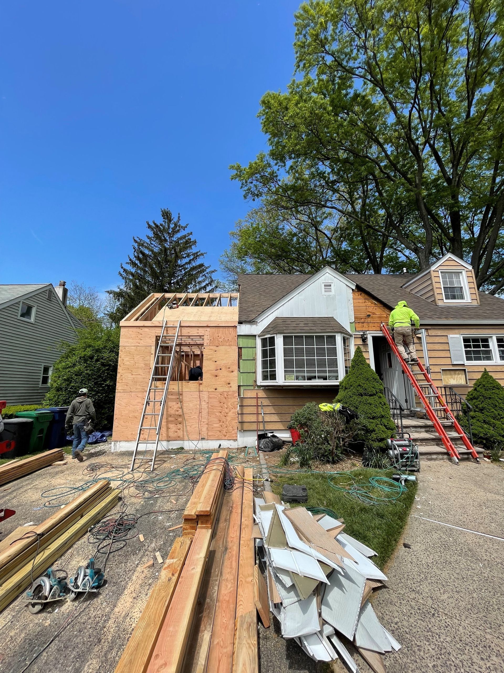 A house is being remodeled with a new roof.