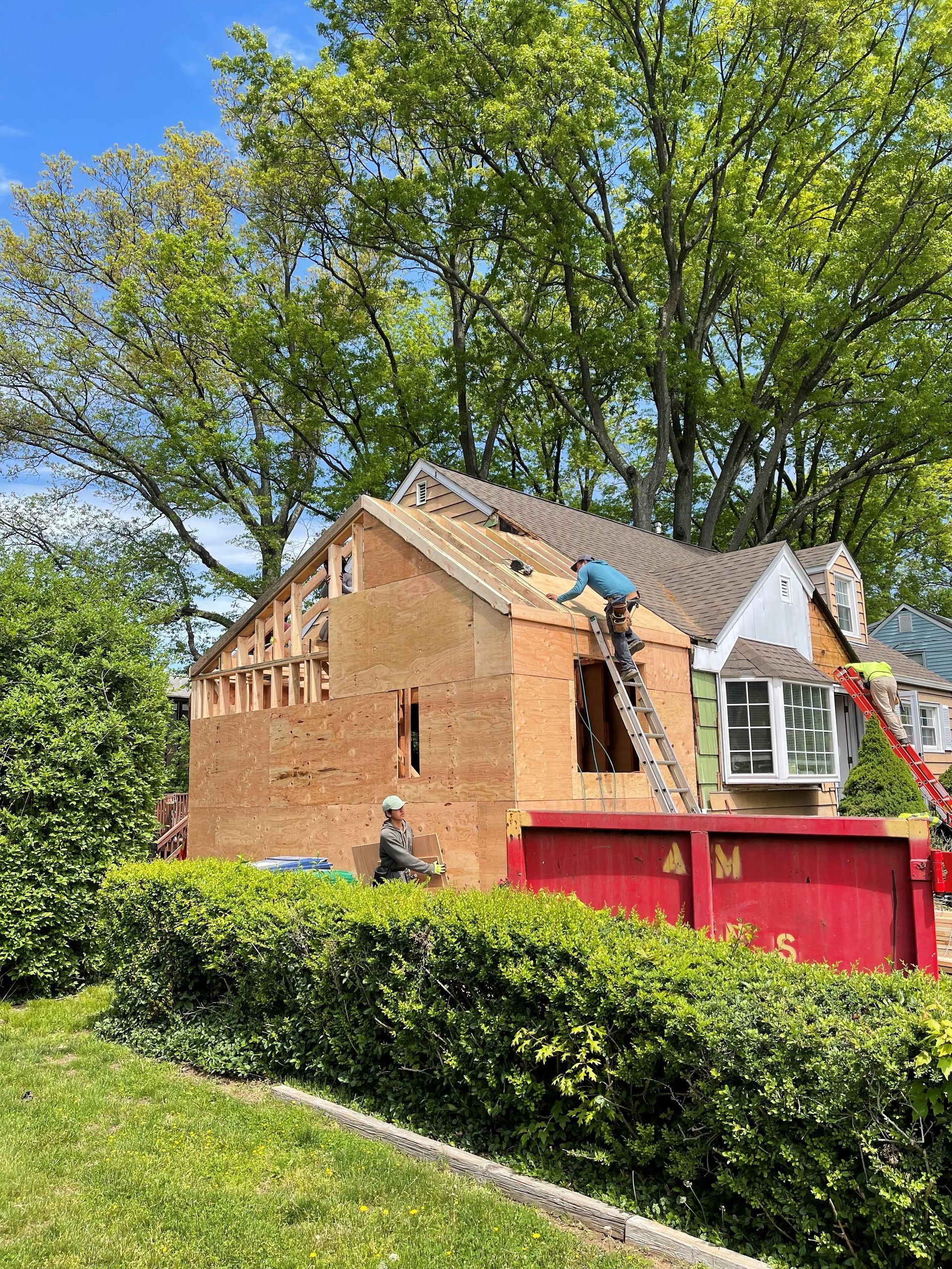 A man is working on the roof of a house.