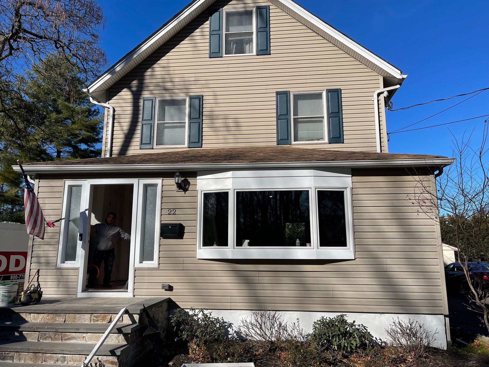 A house with a staircase leading up to the front door