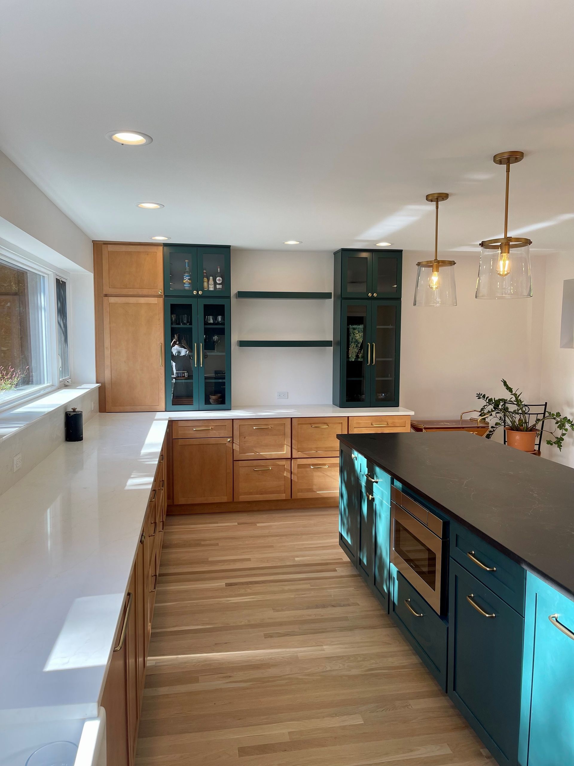 A kitchen with blue cabinets and a black counter top