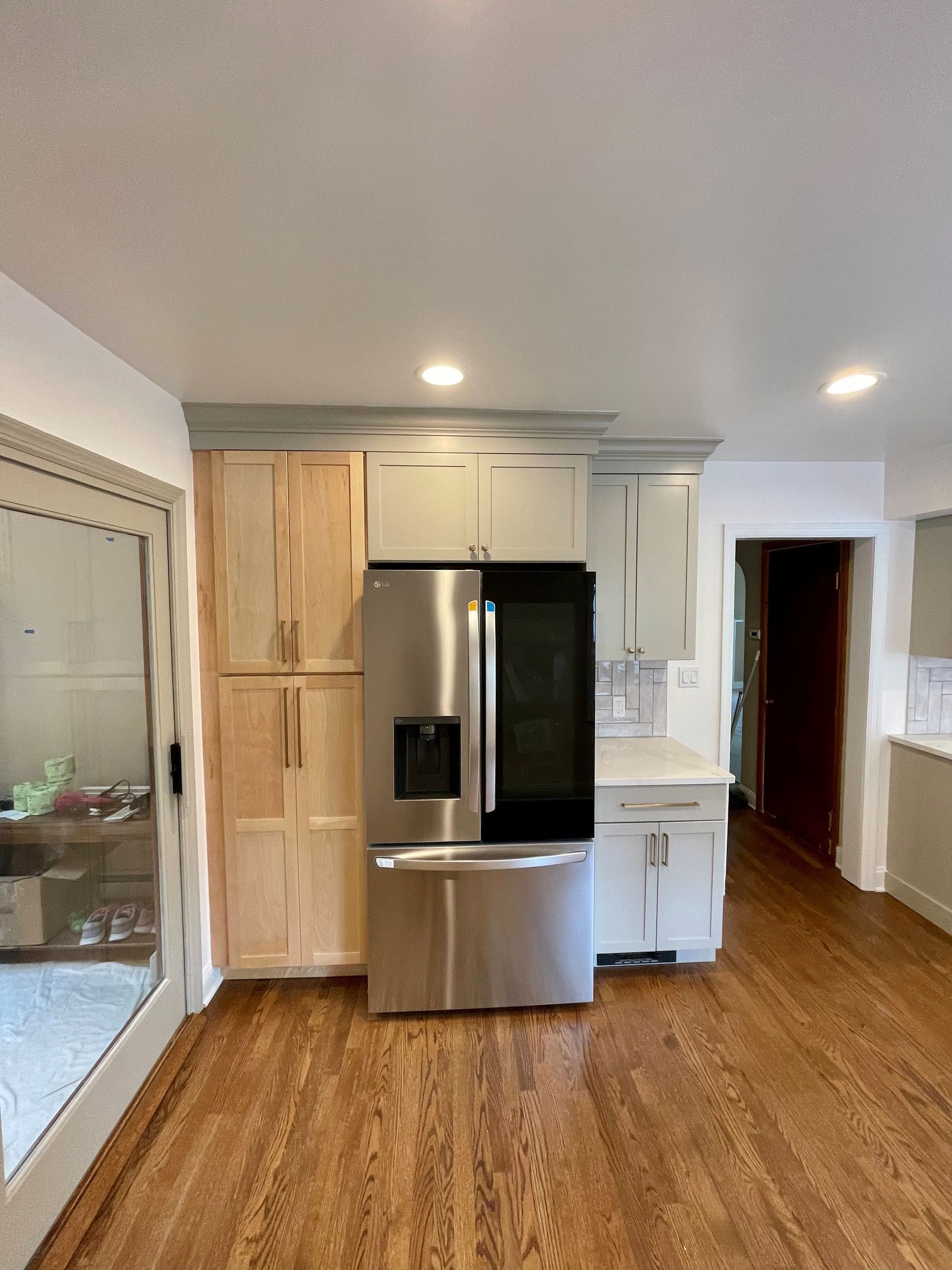 A kitchen with stainless steel appliances and wooden cabinets