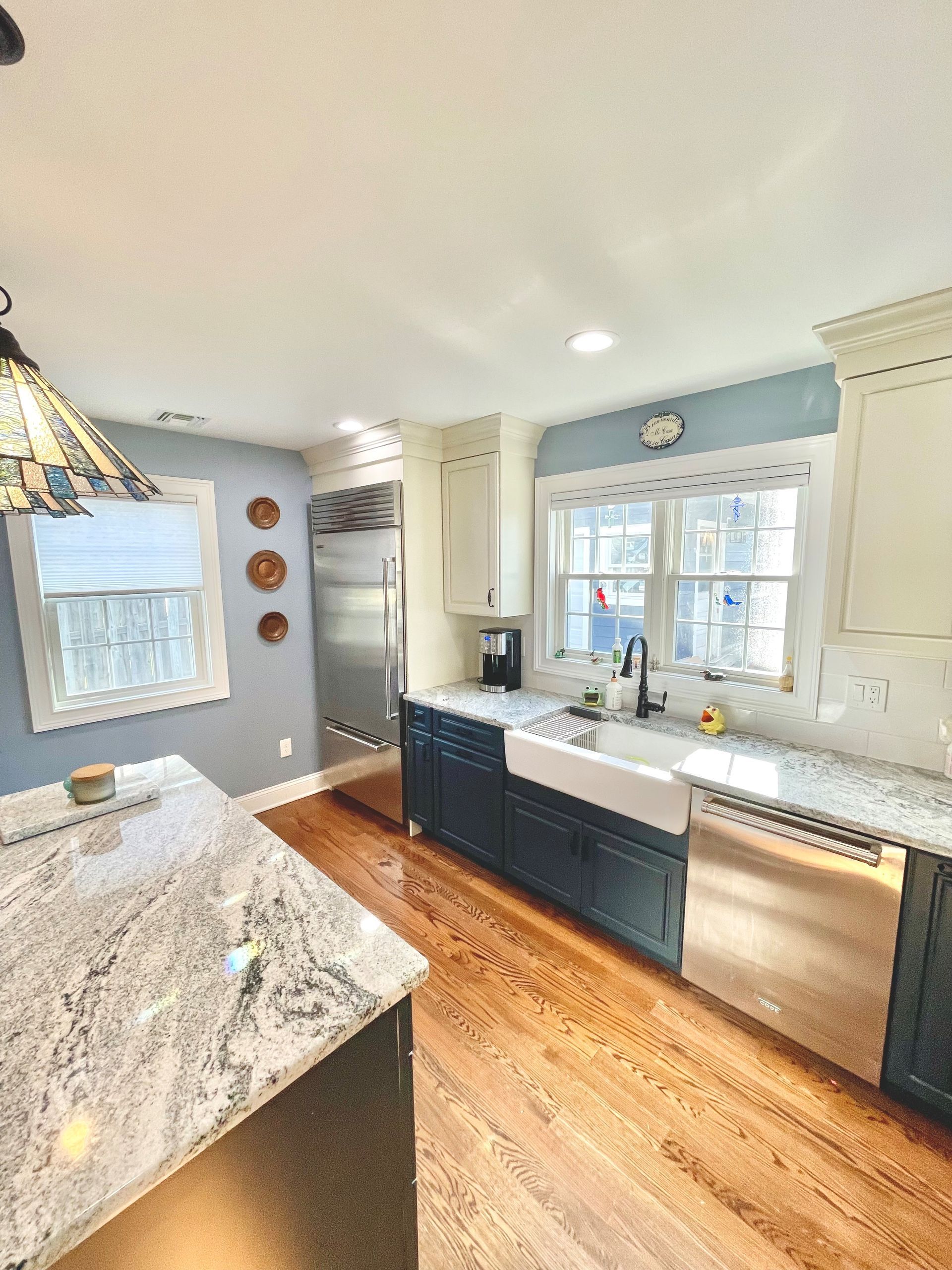 A kitchen with stainless steel appliances, granite counter tops, and a sink.