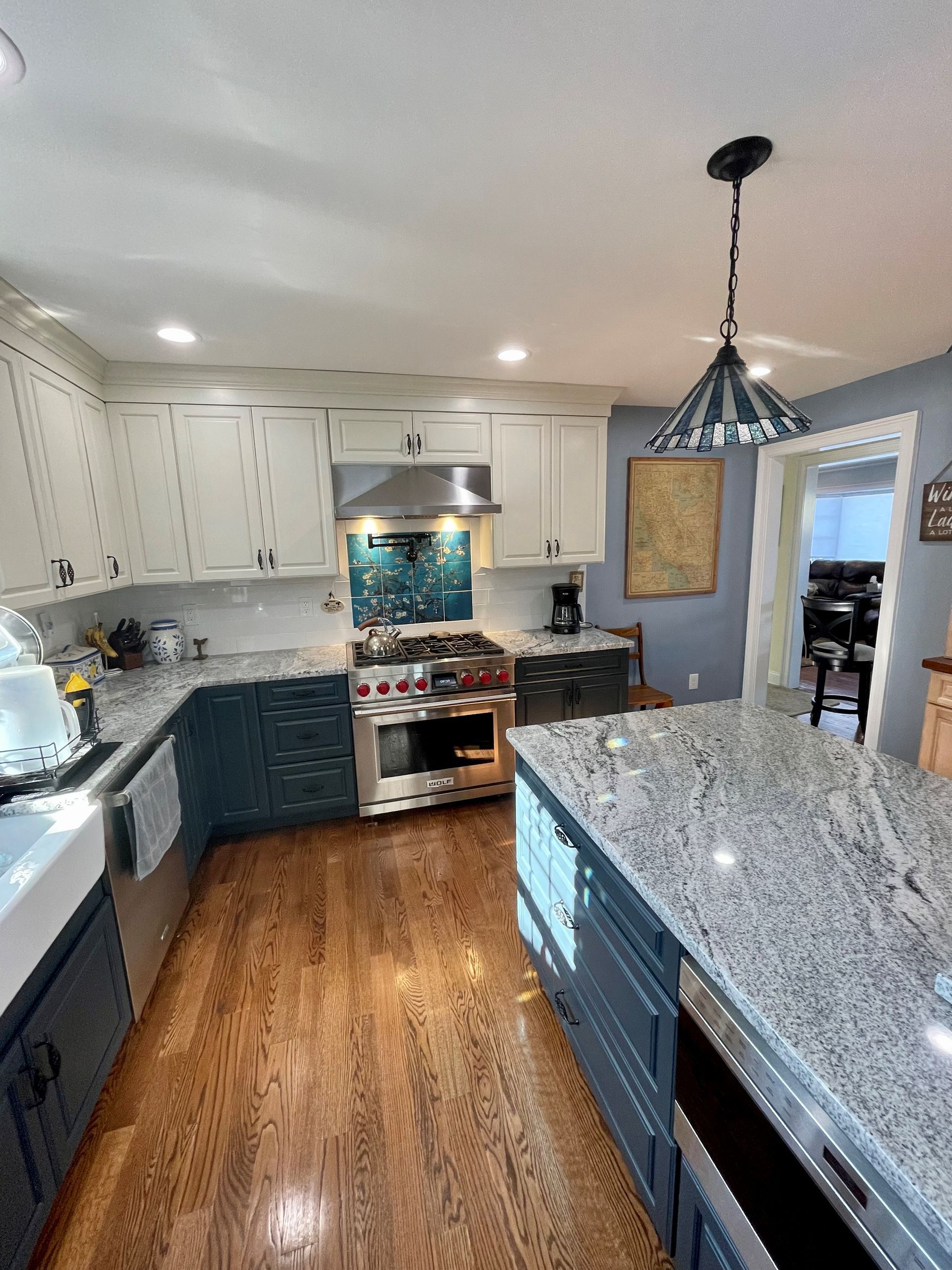 A kitchen with granite counter tops and stainless steel appliances.