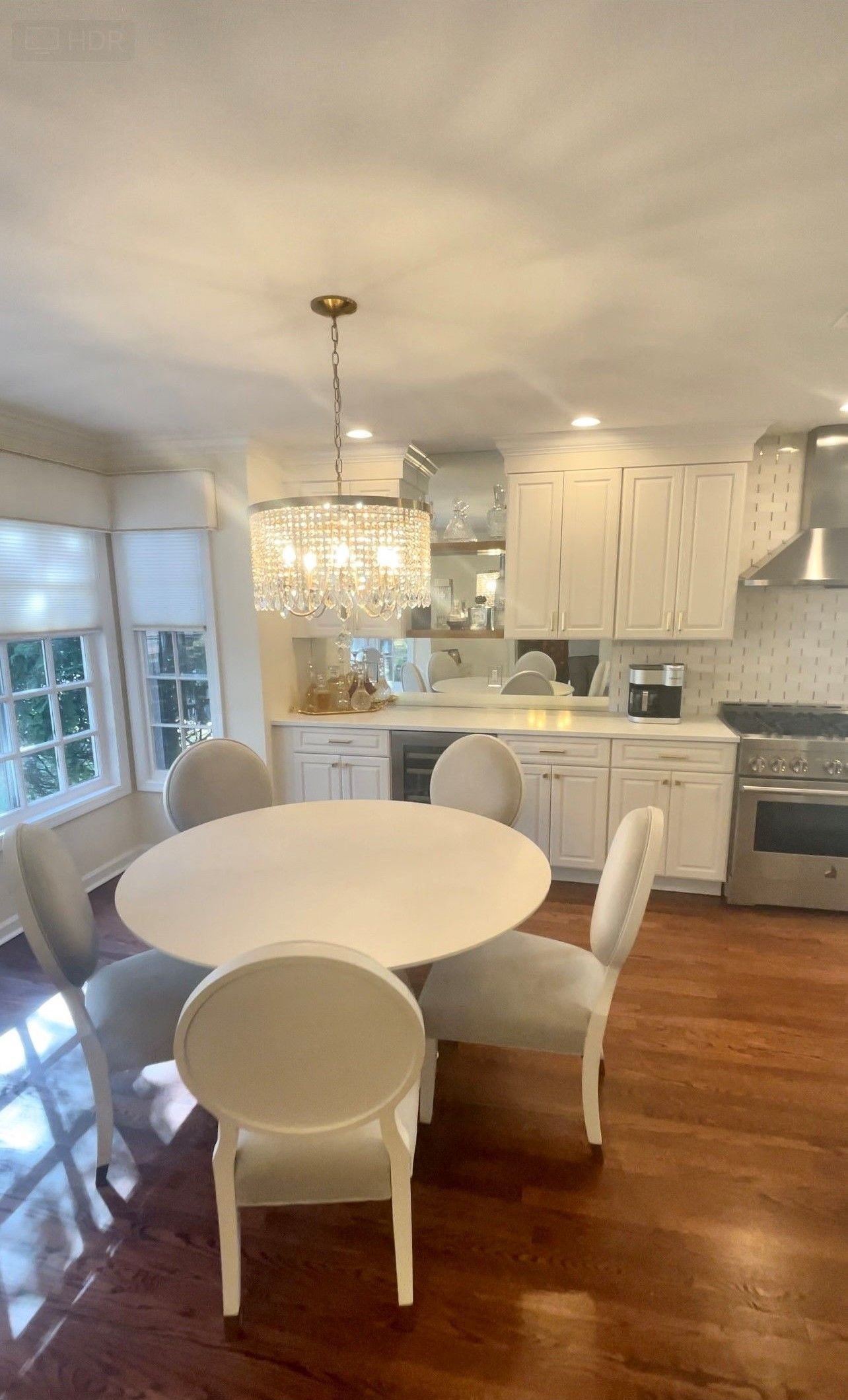 A kitchen with a round table and chairs in it.