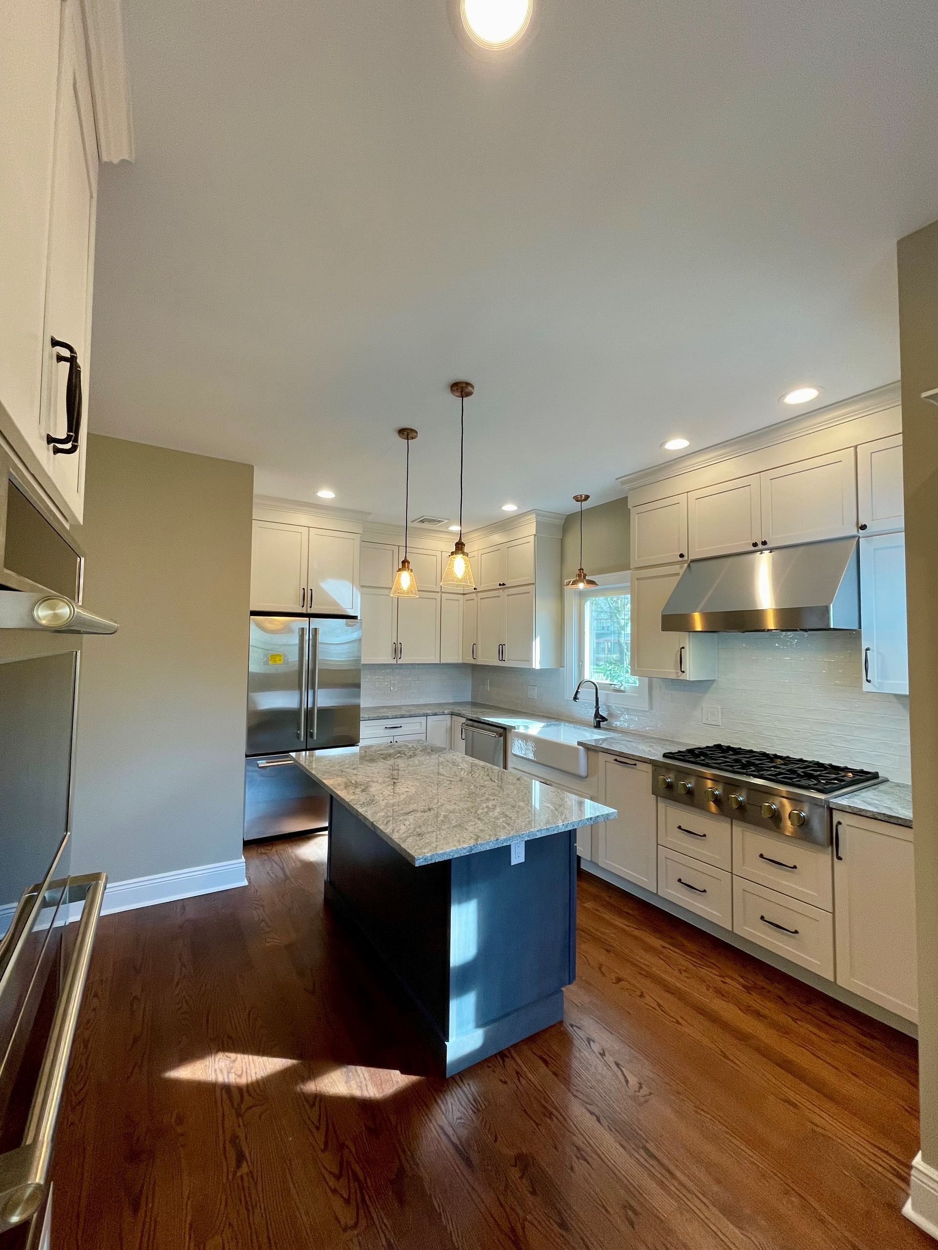 A kitchen with white cabinets and stainless steel appliances