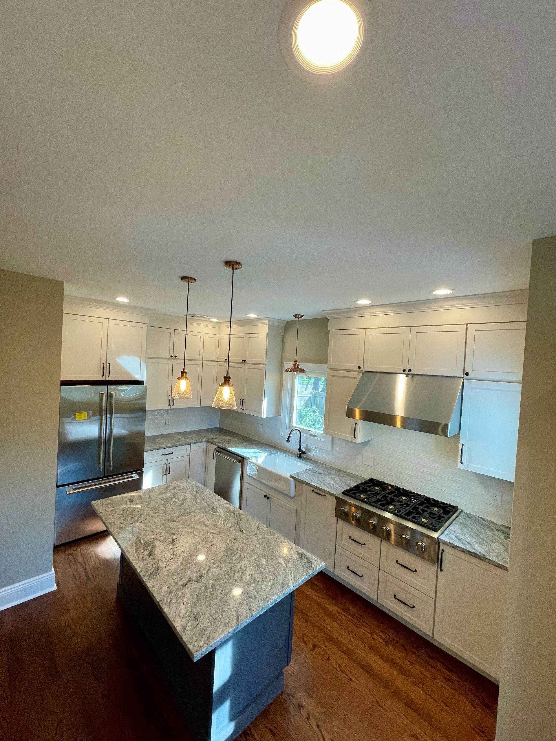 A kitchen with stainless steel appliances and granite counter tops