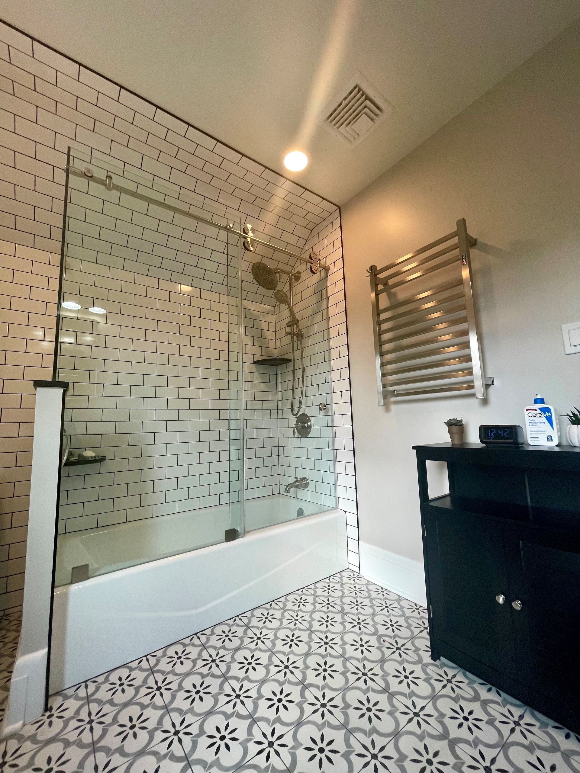 A bathroom with a walk in shower and a bathtub.