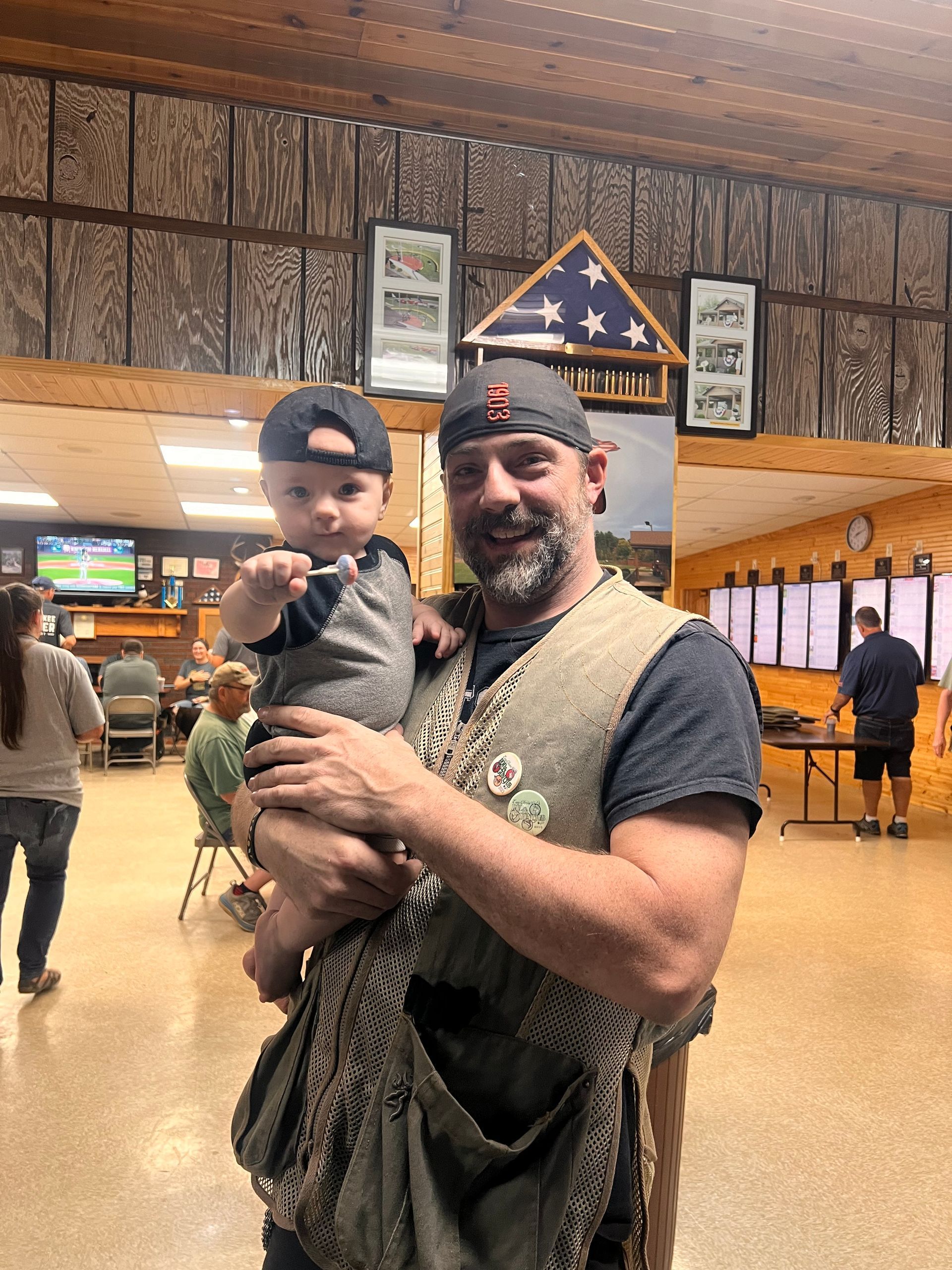 A man is holding a baby in his arms in a room