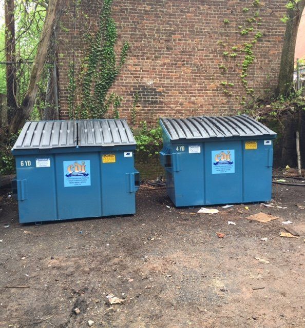 Two blue dumpsters with a sticker that says ' aol ' on it