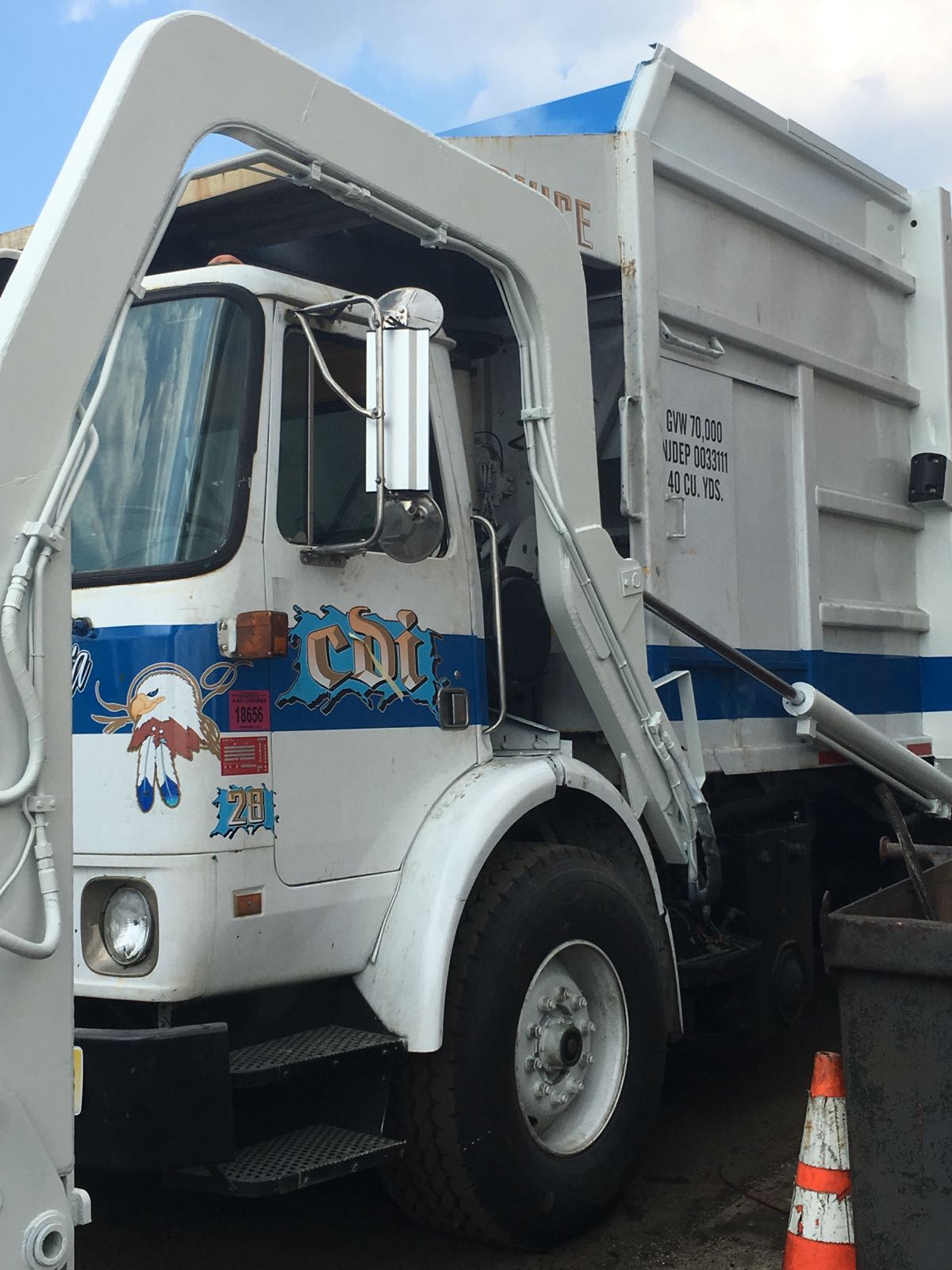 A garbage truck with a snowman on the side of it