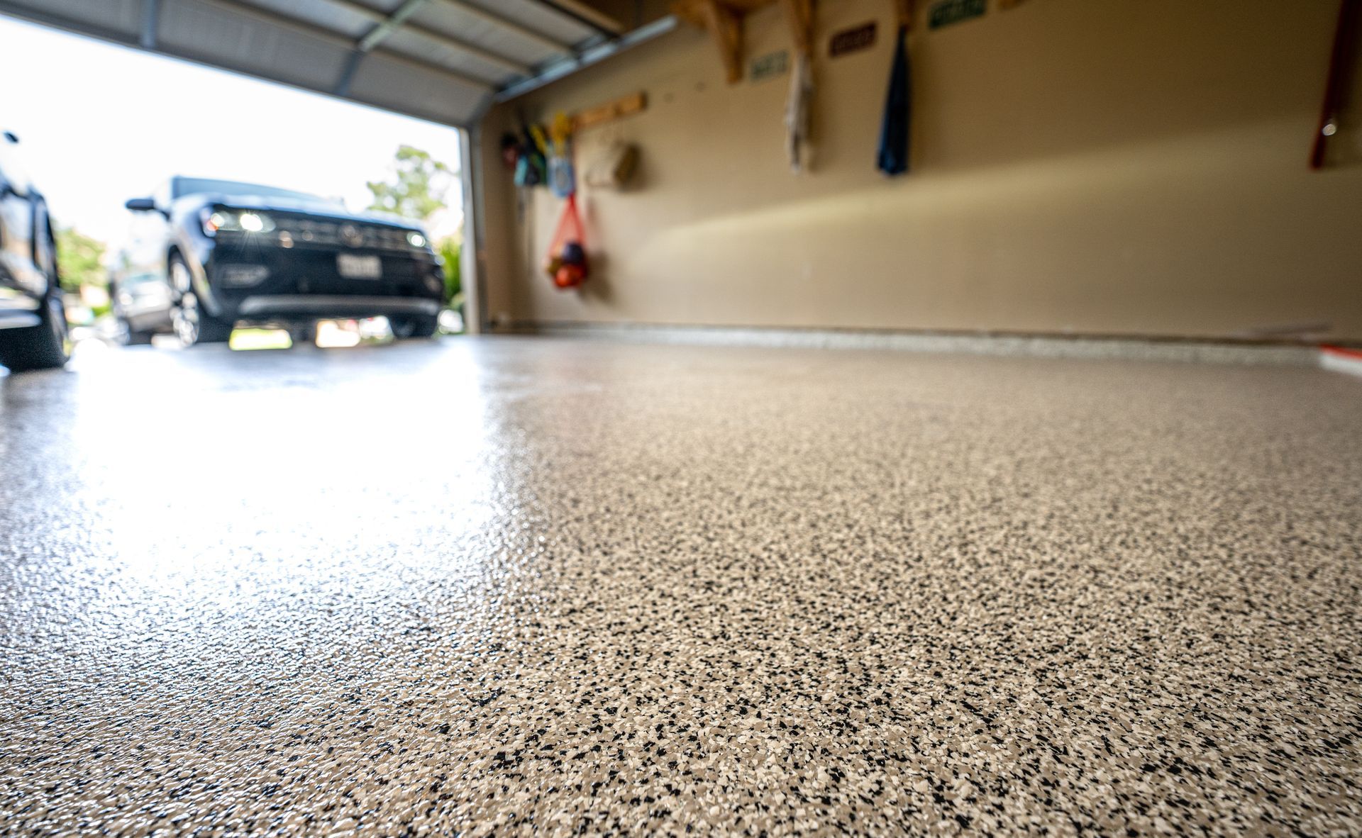 a car is parked in a garage with a concrete epoxy floor coatings.