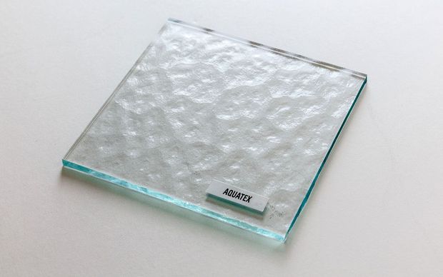 Clear glass pieces, various shapes: flat, curved, and angular, against a white background.