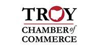 The troy chamber of commerce logo is on a white background.
