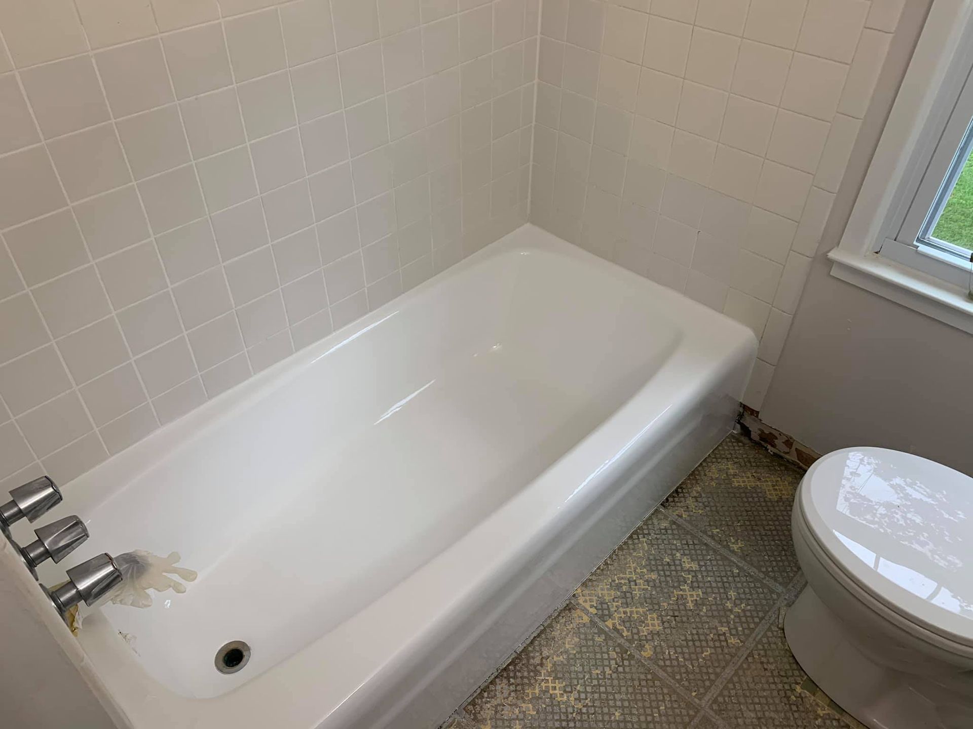 There is a bathtub and a toilet in the bathroom