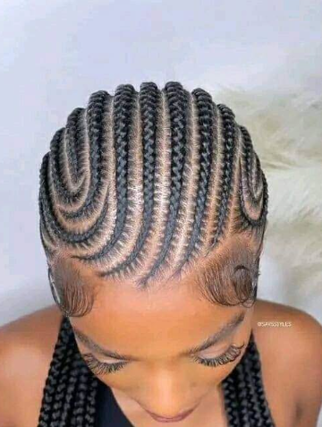 Braided black hair styled in curved rows.