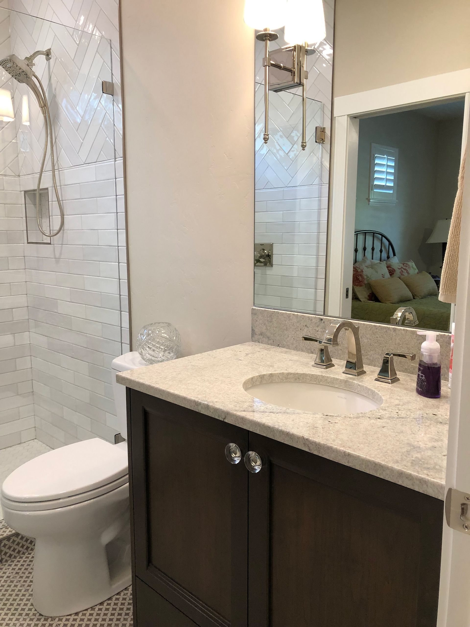 a bathroom with a toilet , sink and mirror