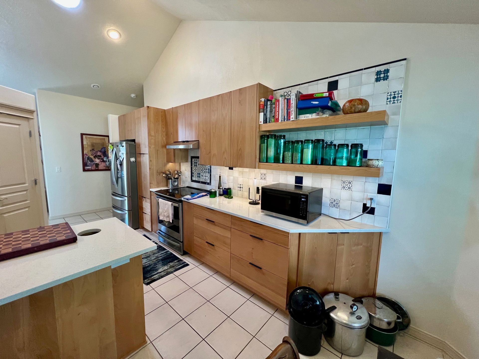 a kitchen with wooden cabinets and stainless steel appliances .