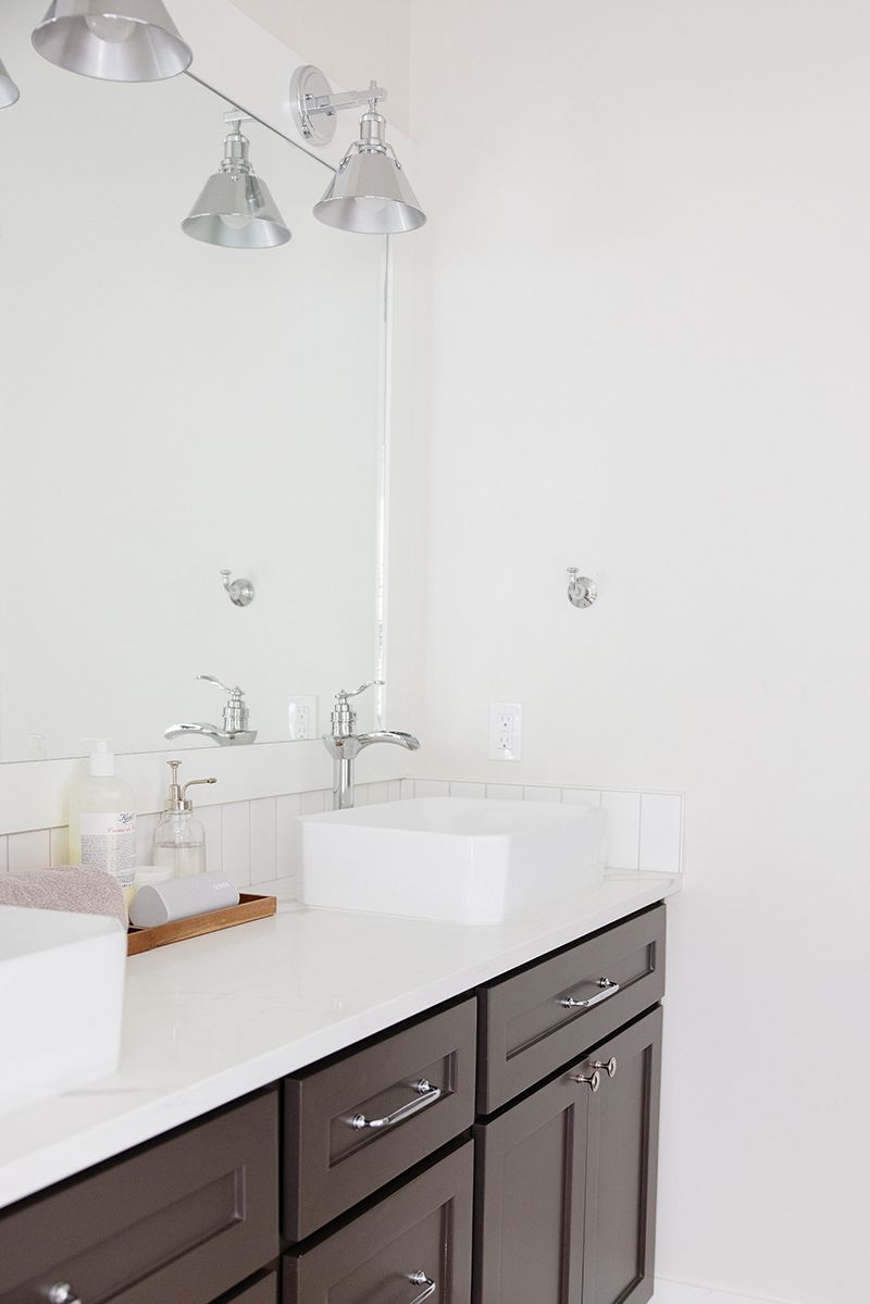 a bathroom with two sinks and a mirror .