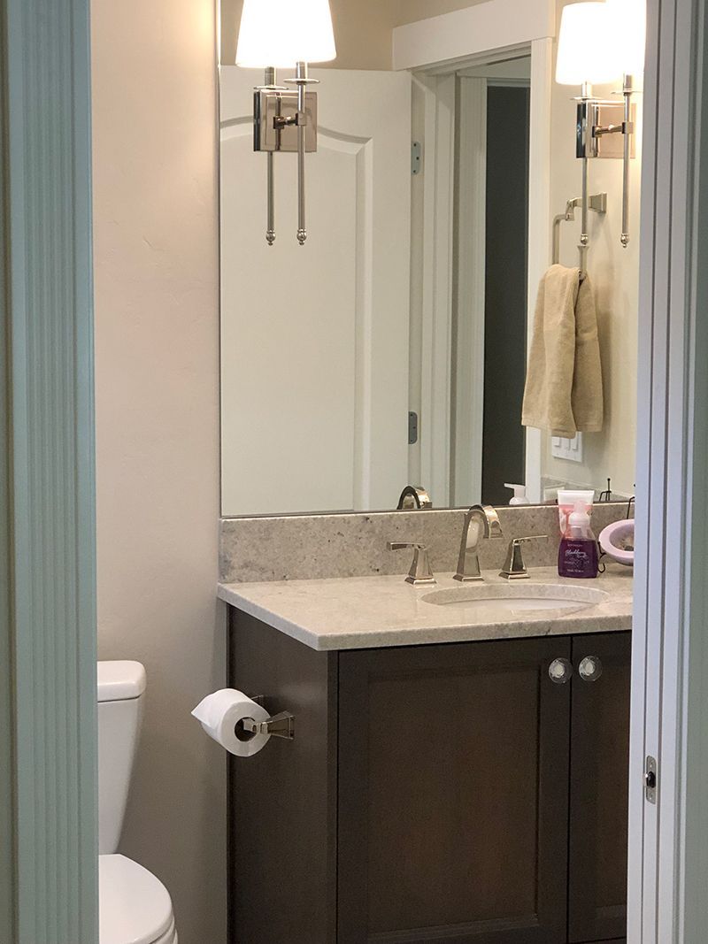 a bathroom with a toilet a sink and a mirror