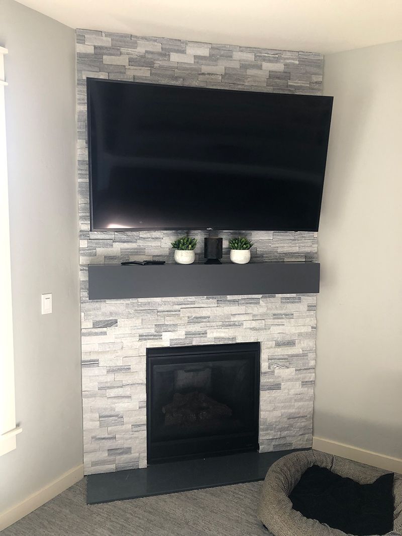a fireplace with a flat screen tv mounted on the wall above it .