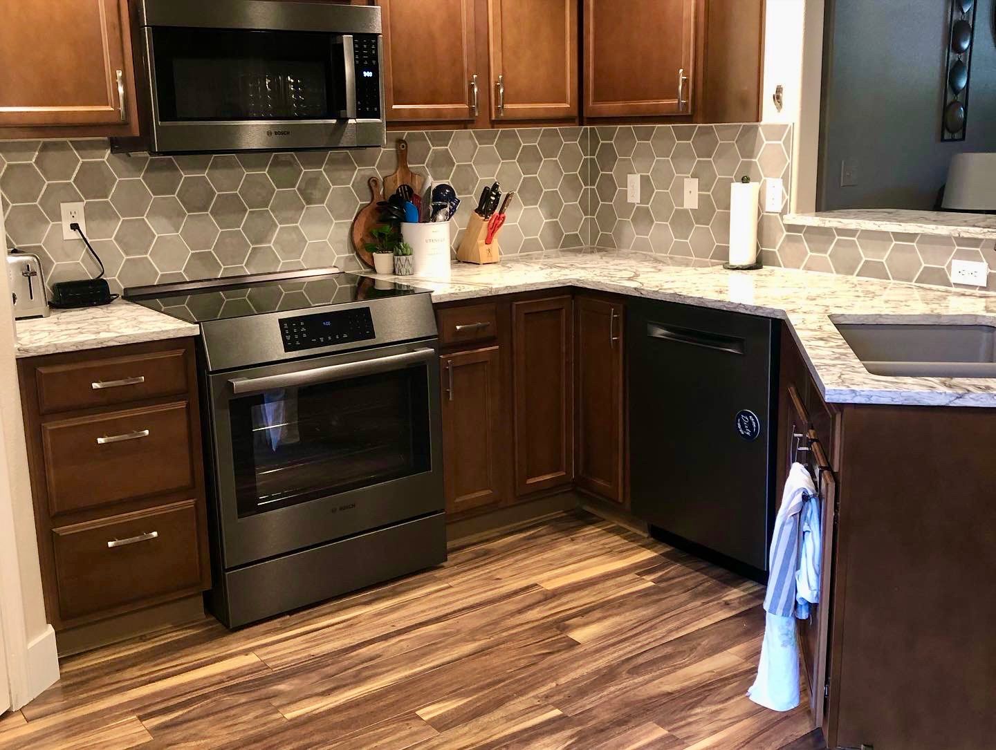 a kitchen with stainless steel appliances and wooden cabinets .