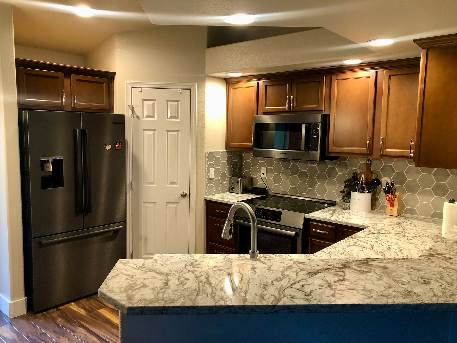 a kitchen with stainless steel appliances and granite counter tops .