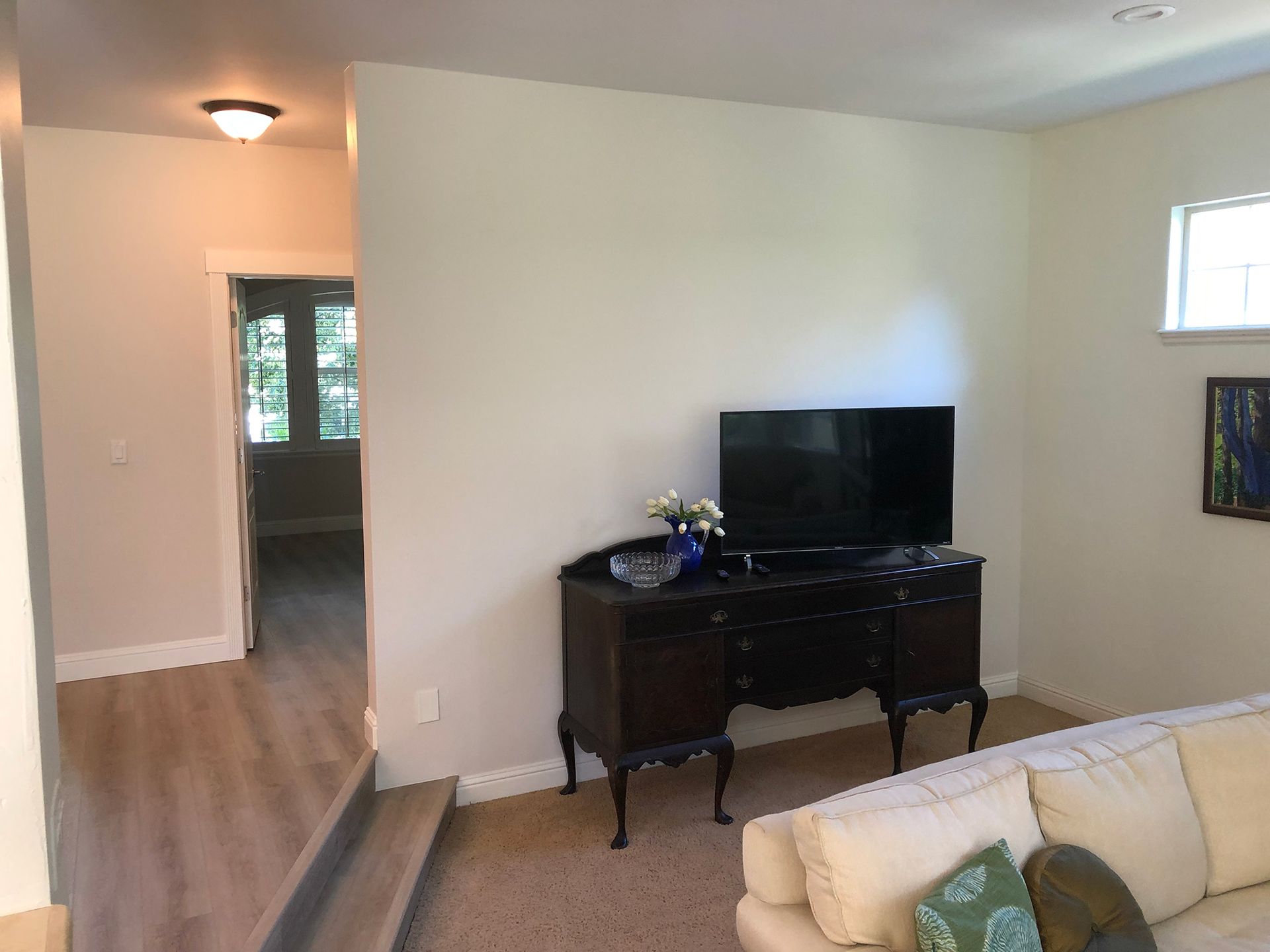 a living room with a couch and a flat screen tv .