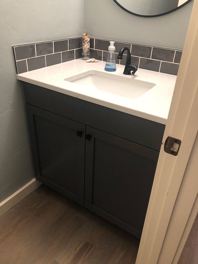 a bathroom vanity with a sink and a mirror .