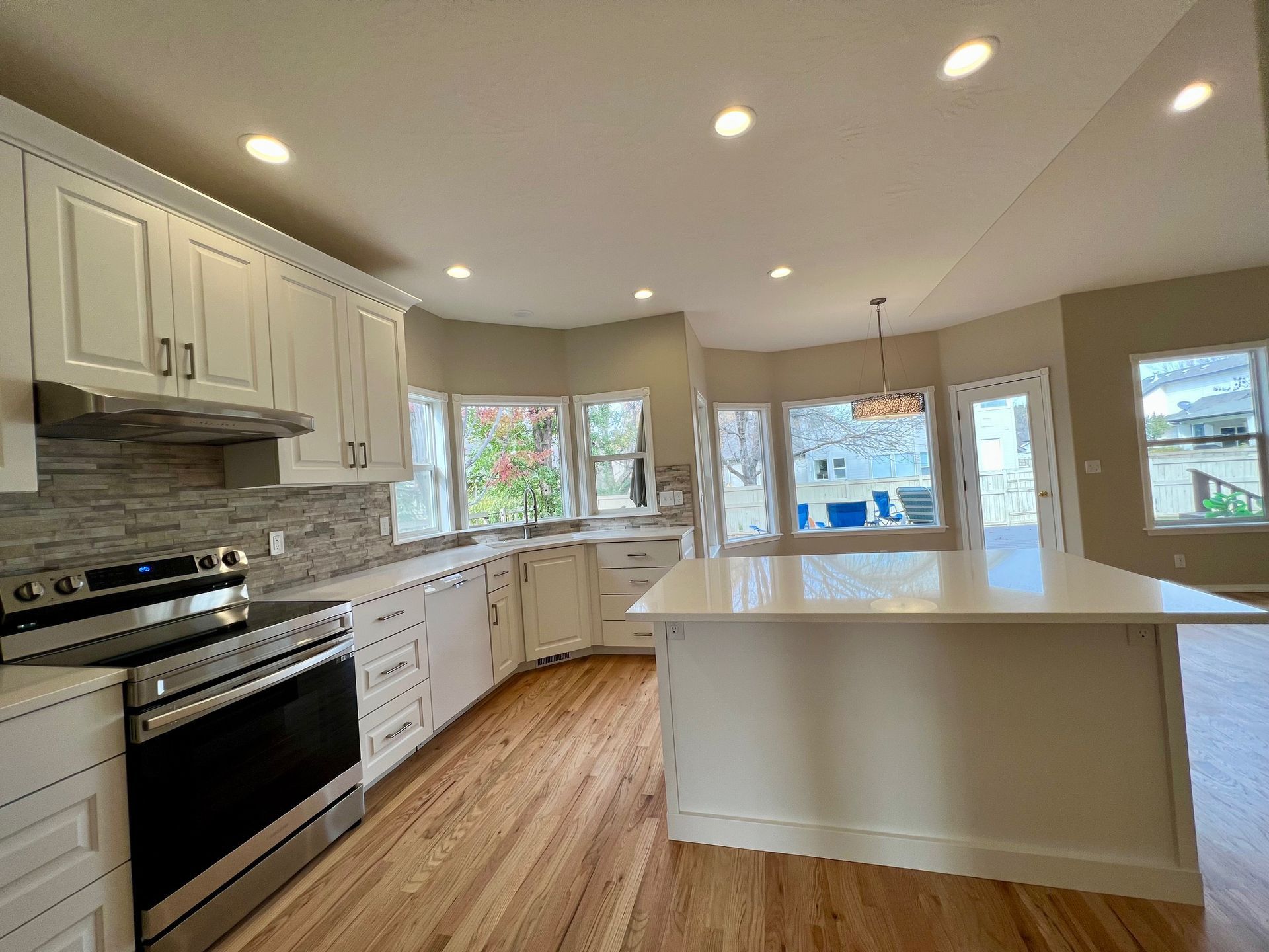 a kitchen with stainless steel appliances and white cabinets