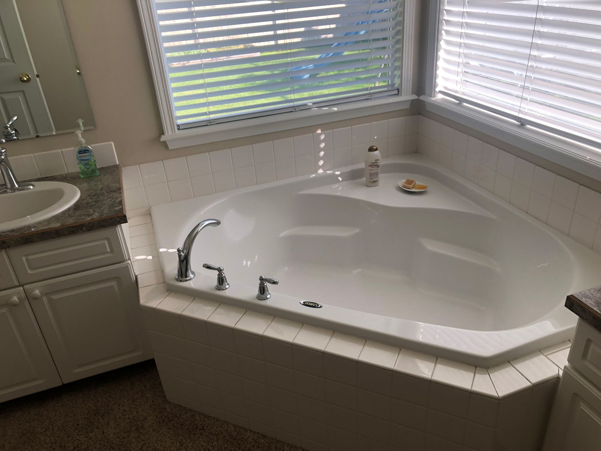 a bathroom with a jacuzzi tub and a sink .