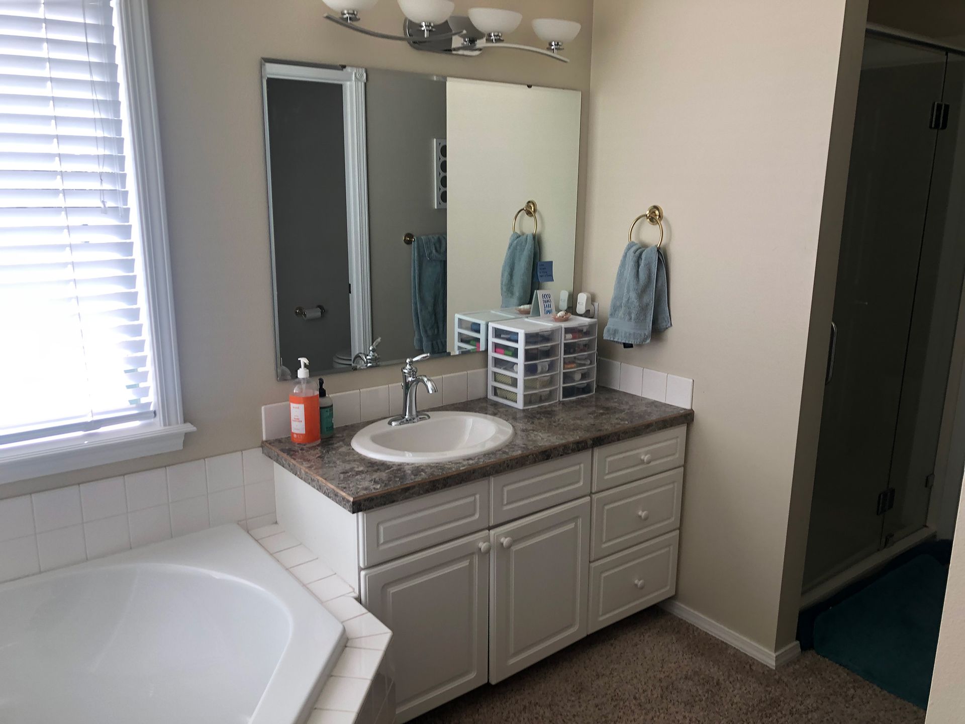 a bathroom with a sink , mirror and tub .