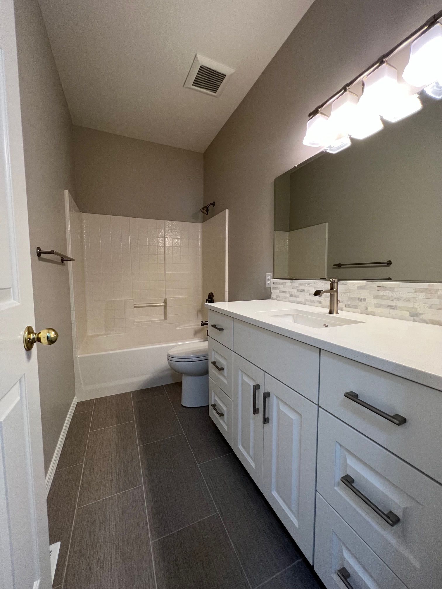 a bathroom with a toilet , sink , and mirror .