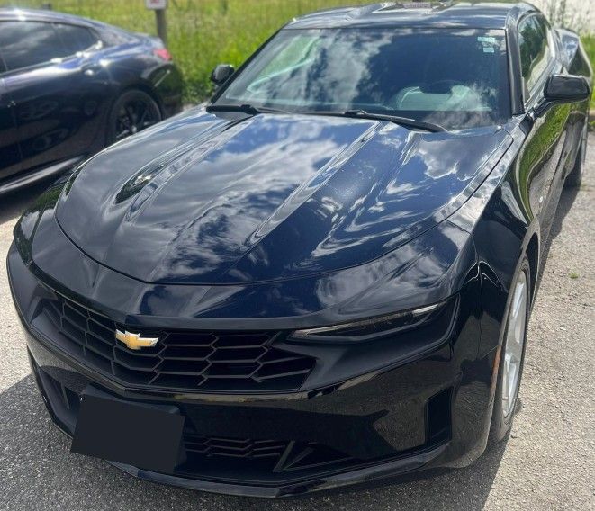 Black Chevrolet Camaro parked outdoors.