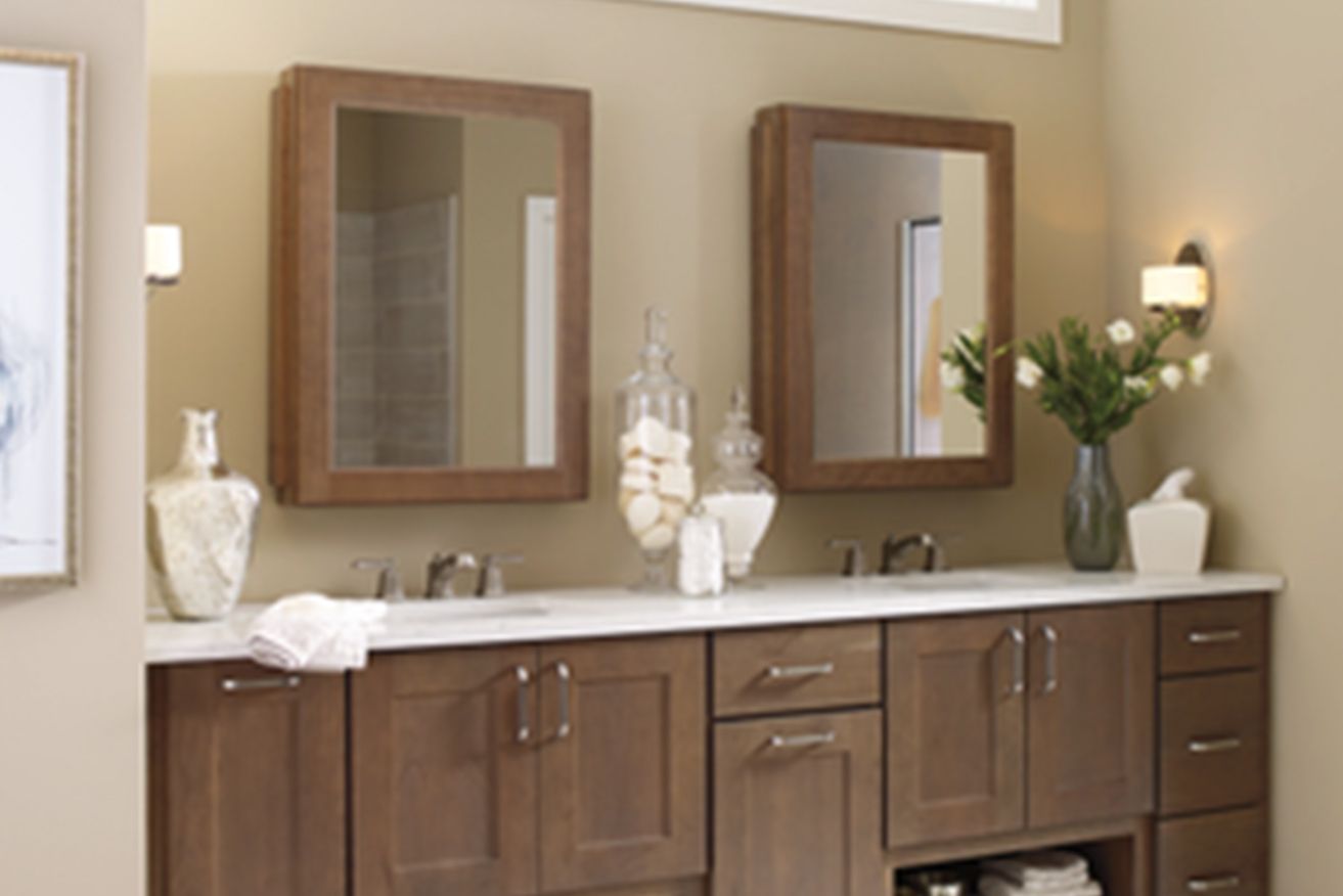 A bathroom with two sinks and two mirrors.