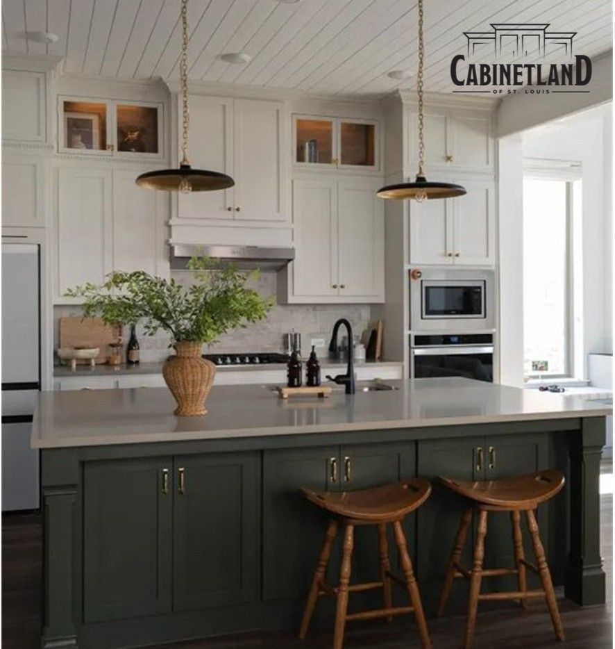 A kitchen with green cabinets and white cabinets and a sign that says cabinetland