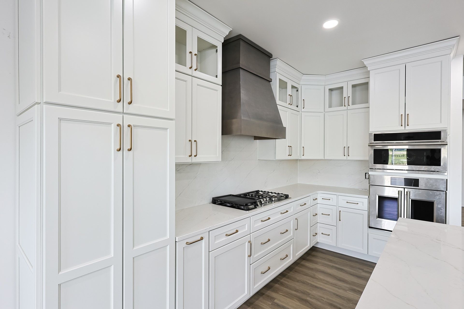 A kitchen with white cabinets and stainless steel appliances.