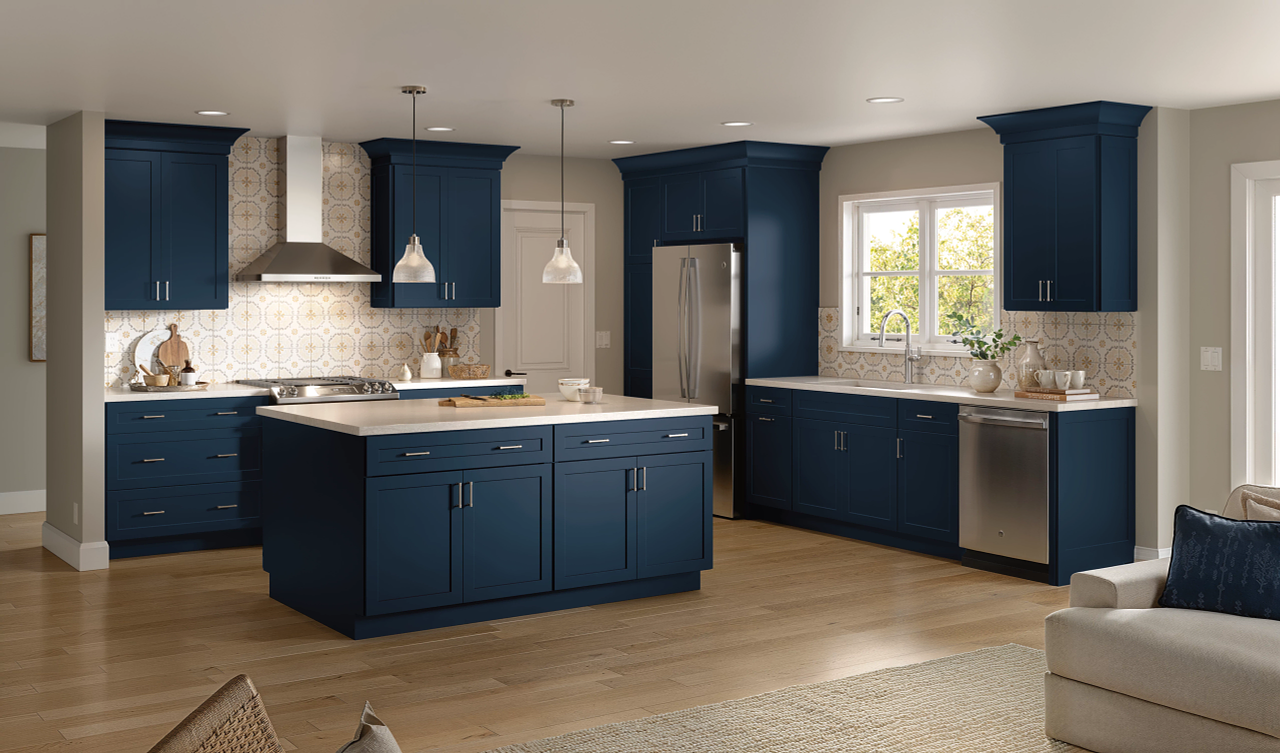 A kitchen with blue cabinets and stainless steel appliances.