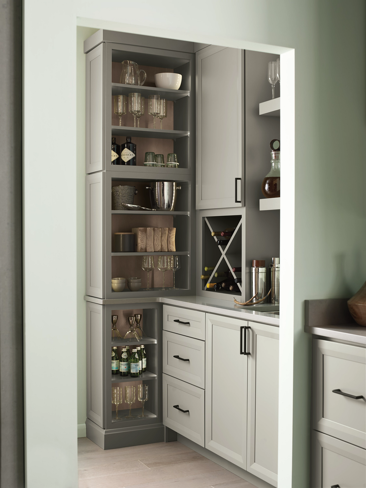 A kitchen with white cabinets and a wine rack