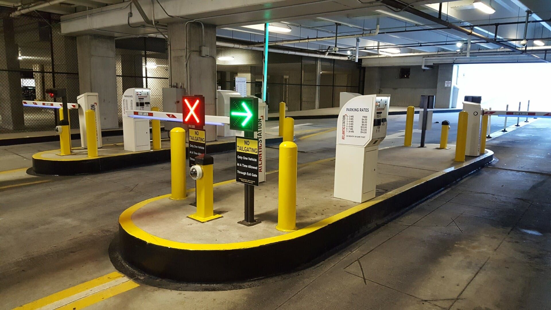 A parking garage with a green sign that says x on it