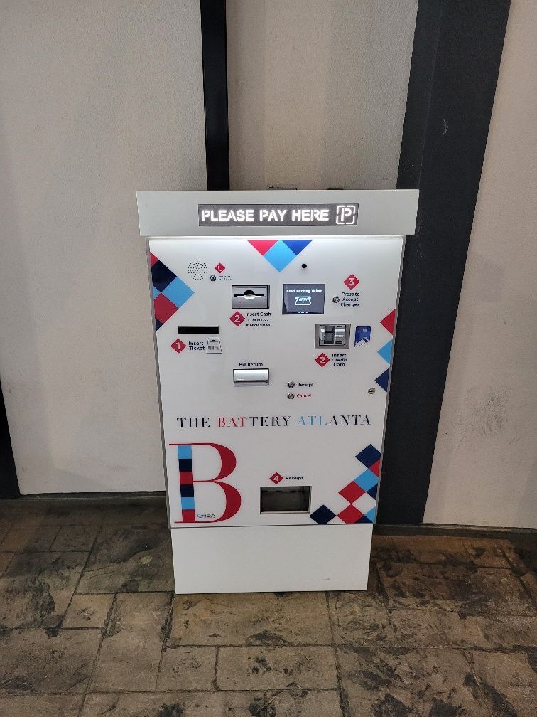 A machine that says please pay here on it