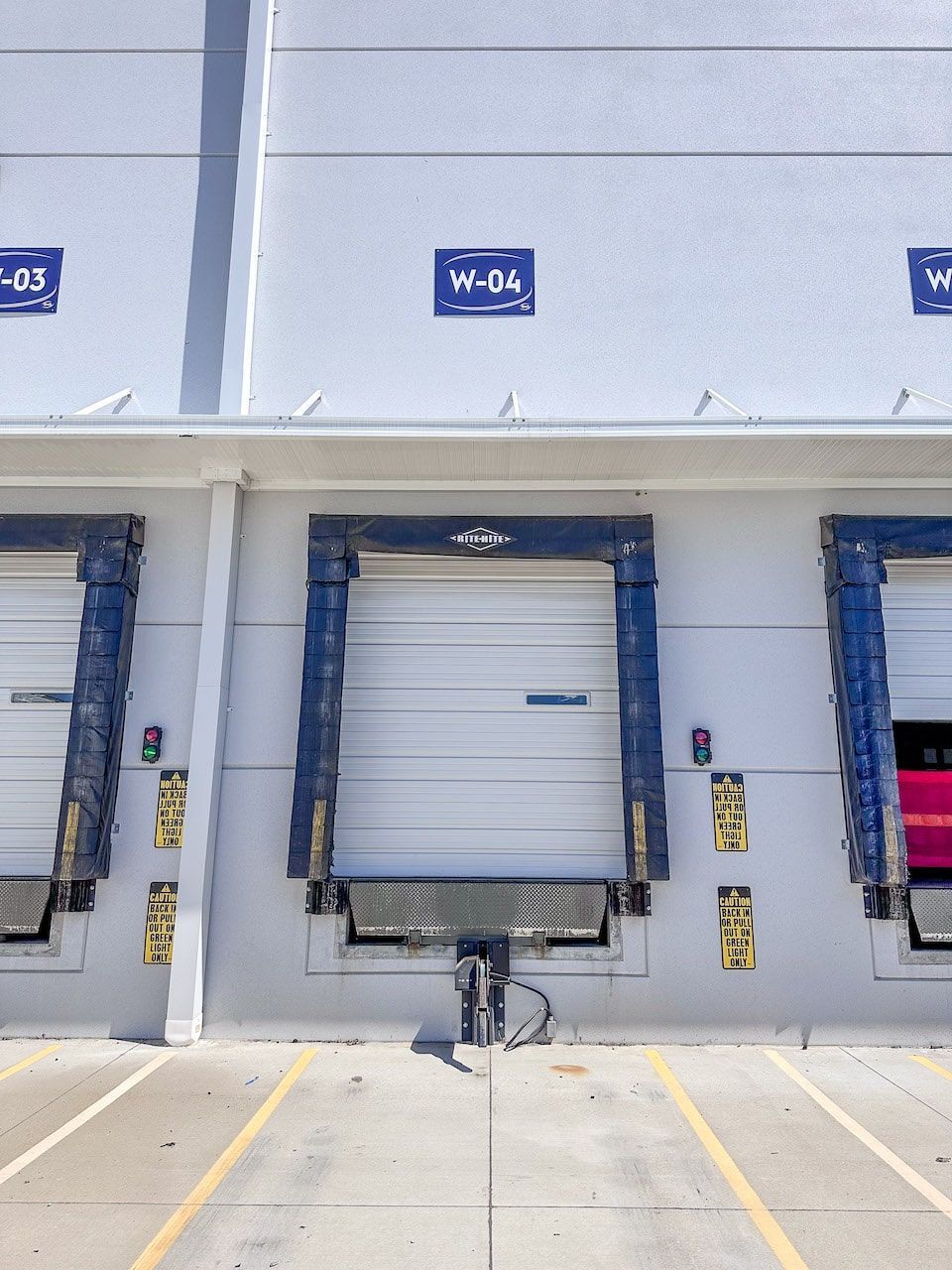 A white building with a blue sign that says w-04 on it