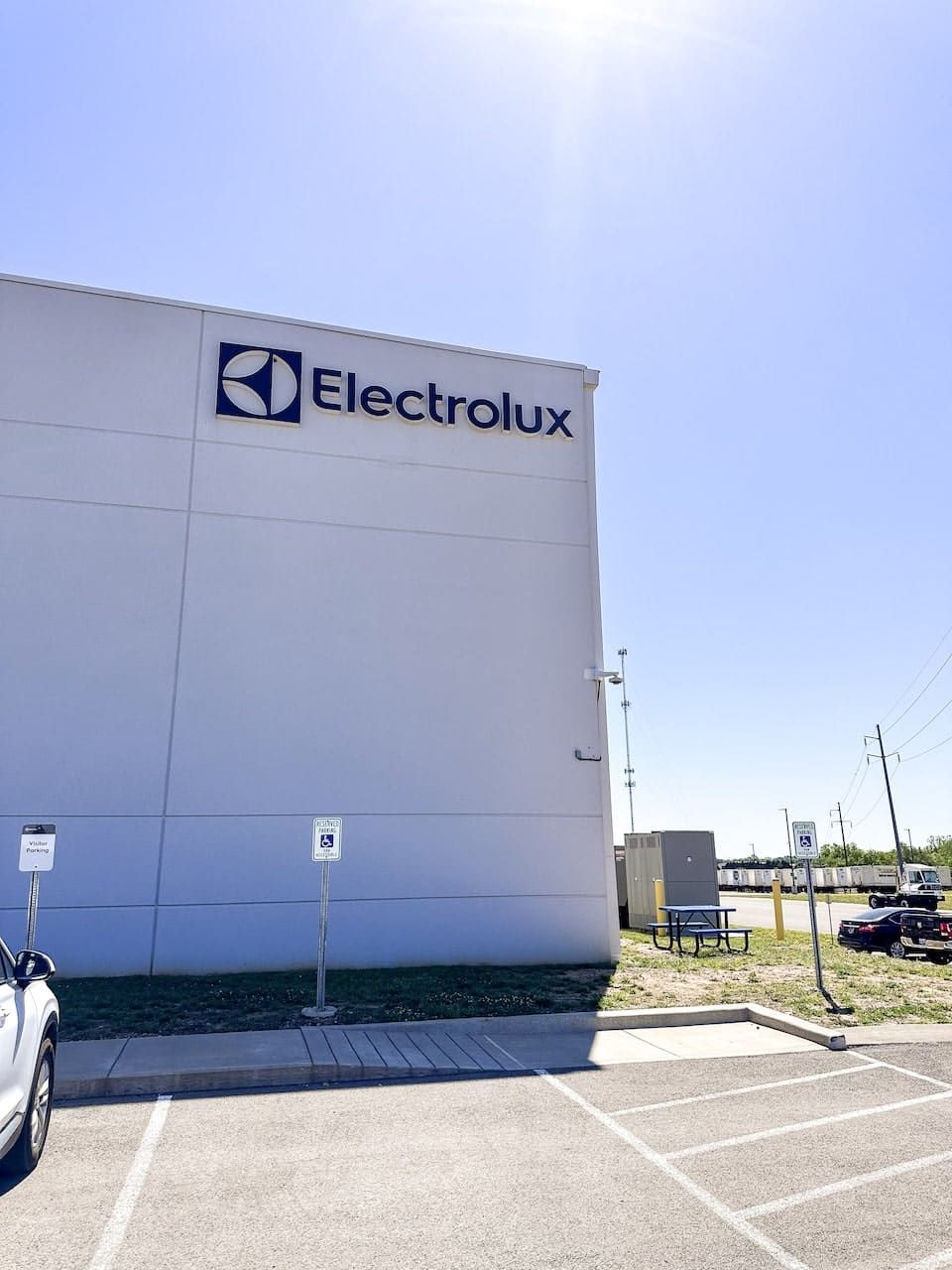 An electrolux building with a parking lot in front of it