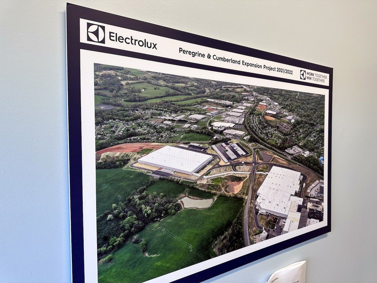 A picture of an aerial view of a city is hanging on a wall.