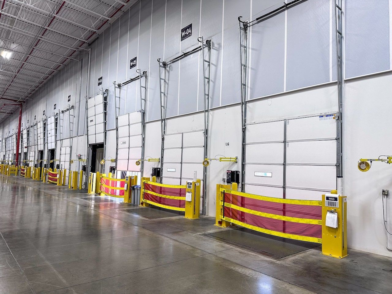 A large warehouse with a lot of doors and barriers.