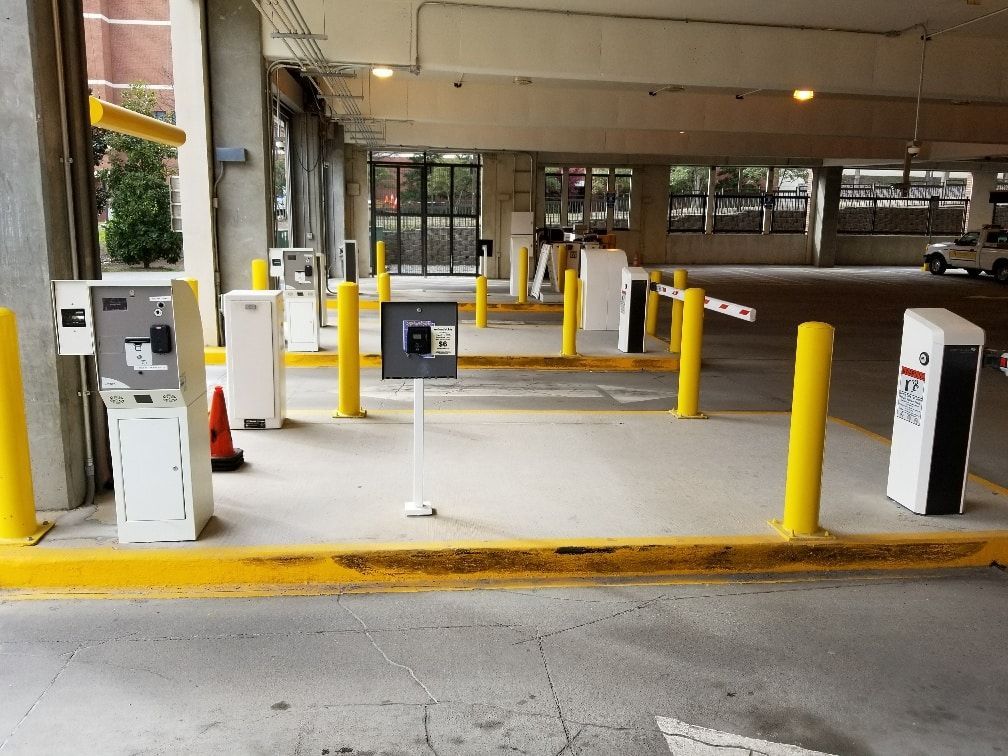 A parking garage with yellow poles and white boxes