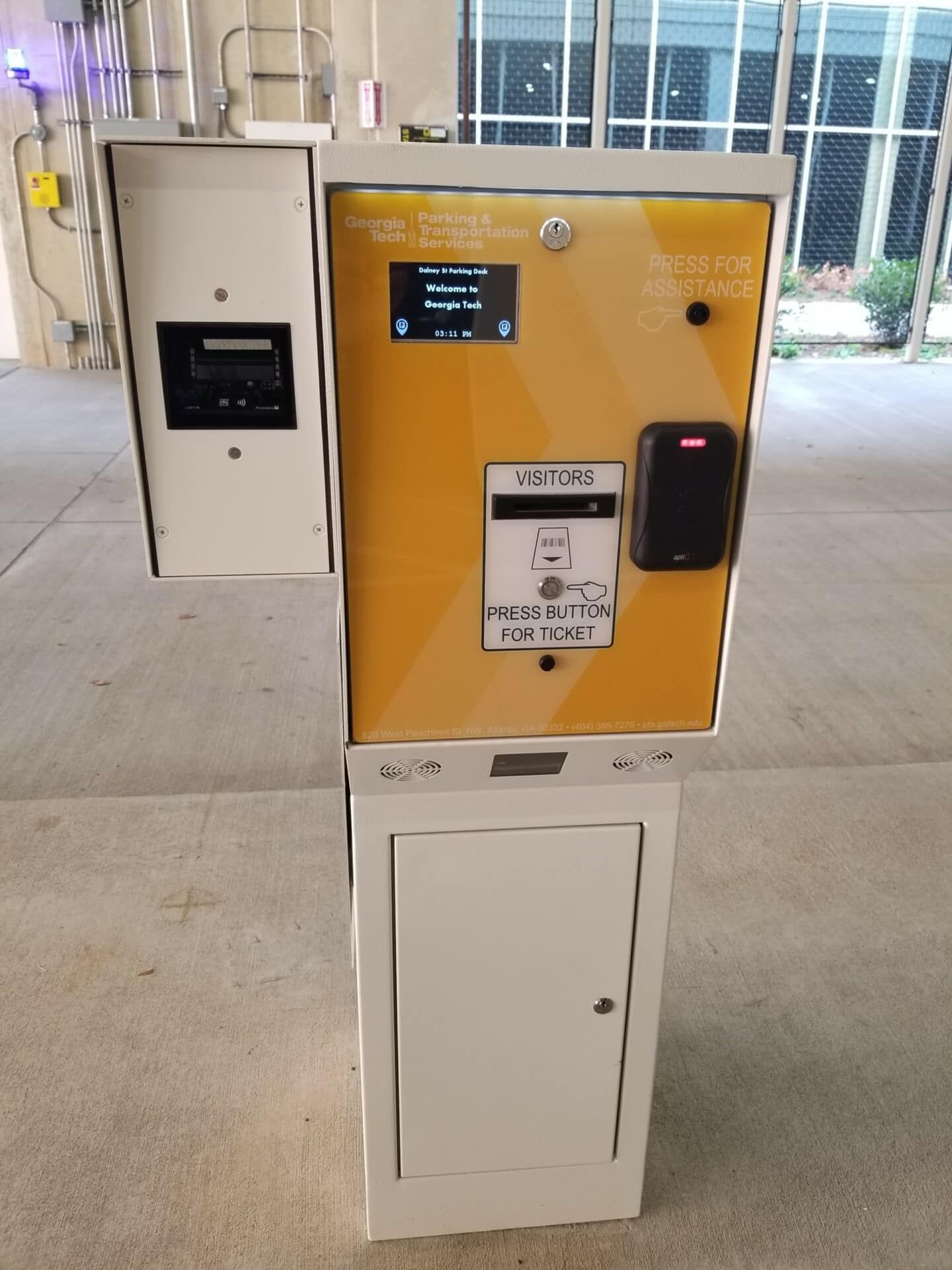 A yellow and white machine that says ' parking ' on it