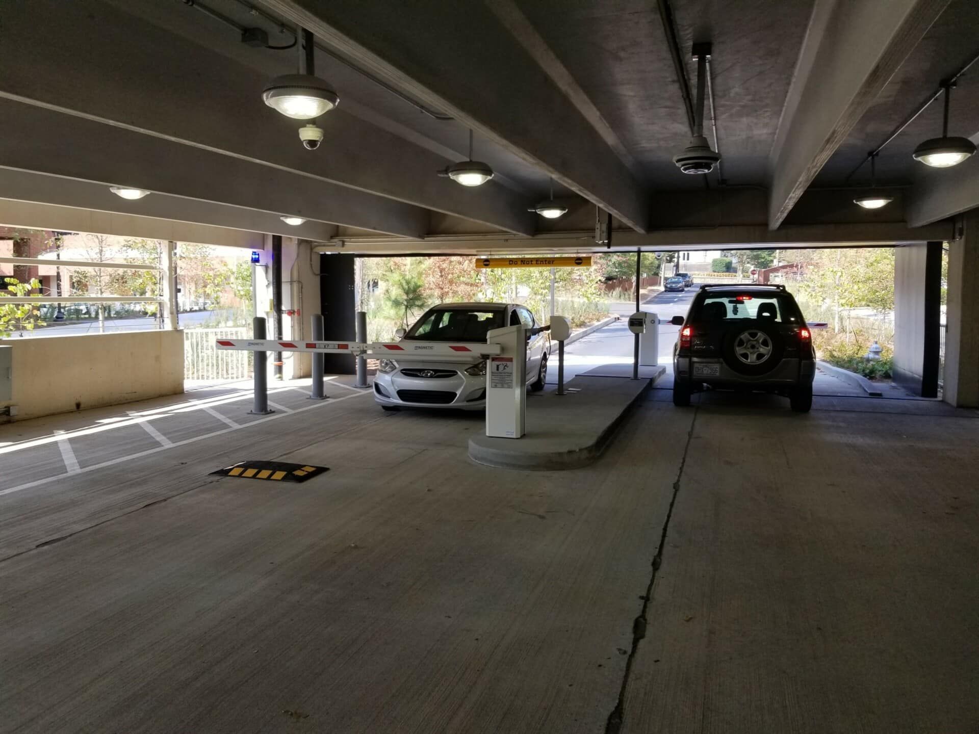 Two cars are parked in a parking garage.