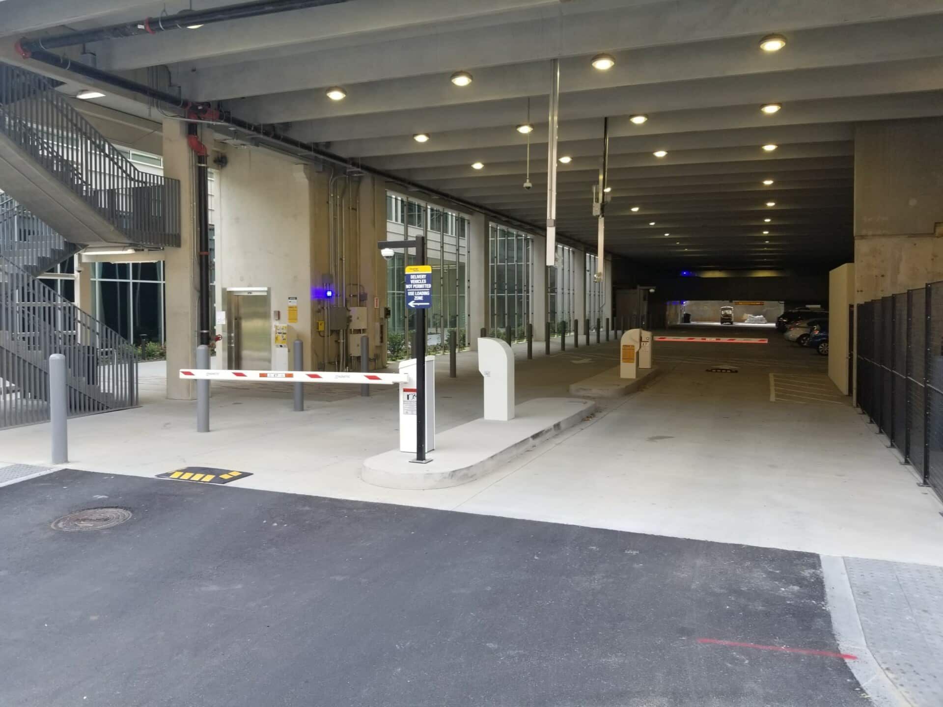 A parking garage with a barrier in the middle of it.
