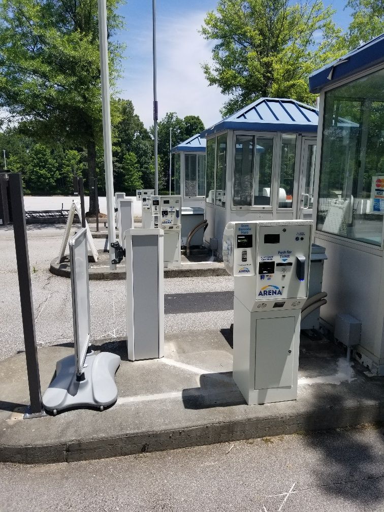 A parking lot with a lot of kiosks and a sign